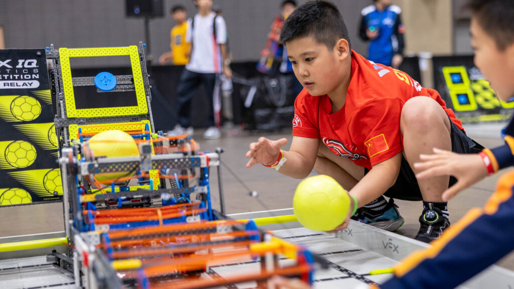 A young boy practicing with VEX IQ Rapid Relay.