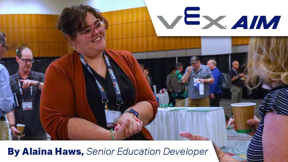 Alaina Haws speaks with a woman at a tradeshow. The text reads "VEX AIM. By Alaina Haws, Senior Education Developer."