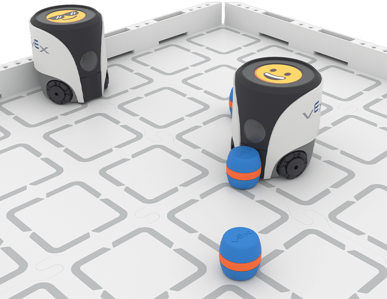 Two VEX AIM robots displaying happy emojis are on a white and grey field. The closer one is moving a blue barrel.
