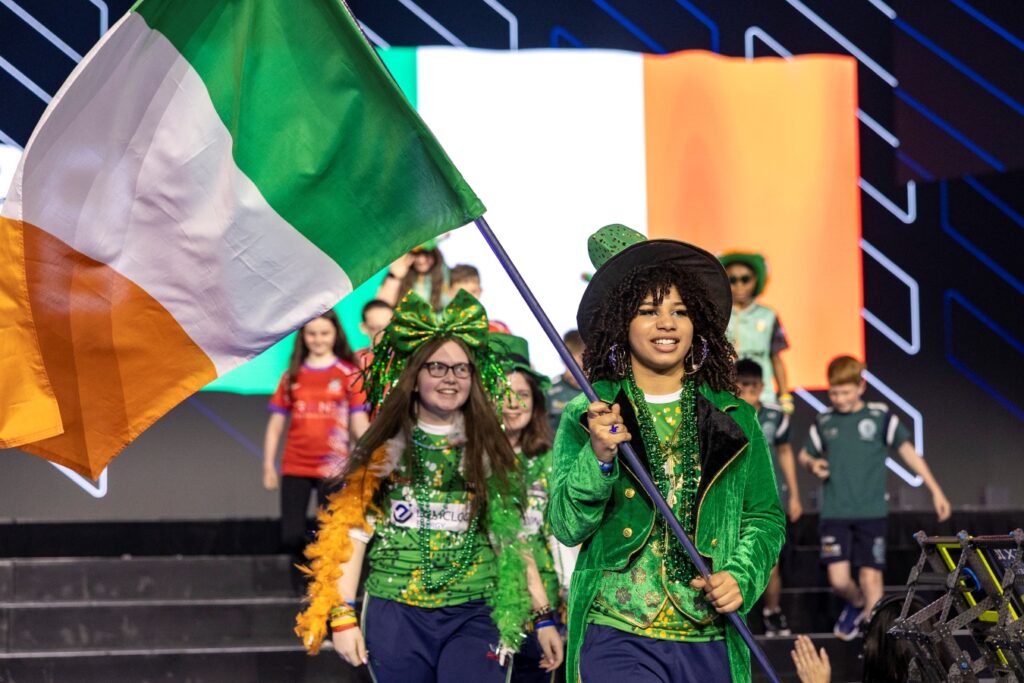 The SHS STEMinists walk in the Parade of Nations at the VEX Robotics World Championship. One member holds the Irish flag.