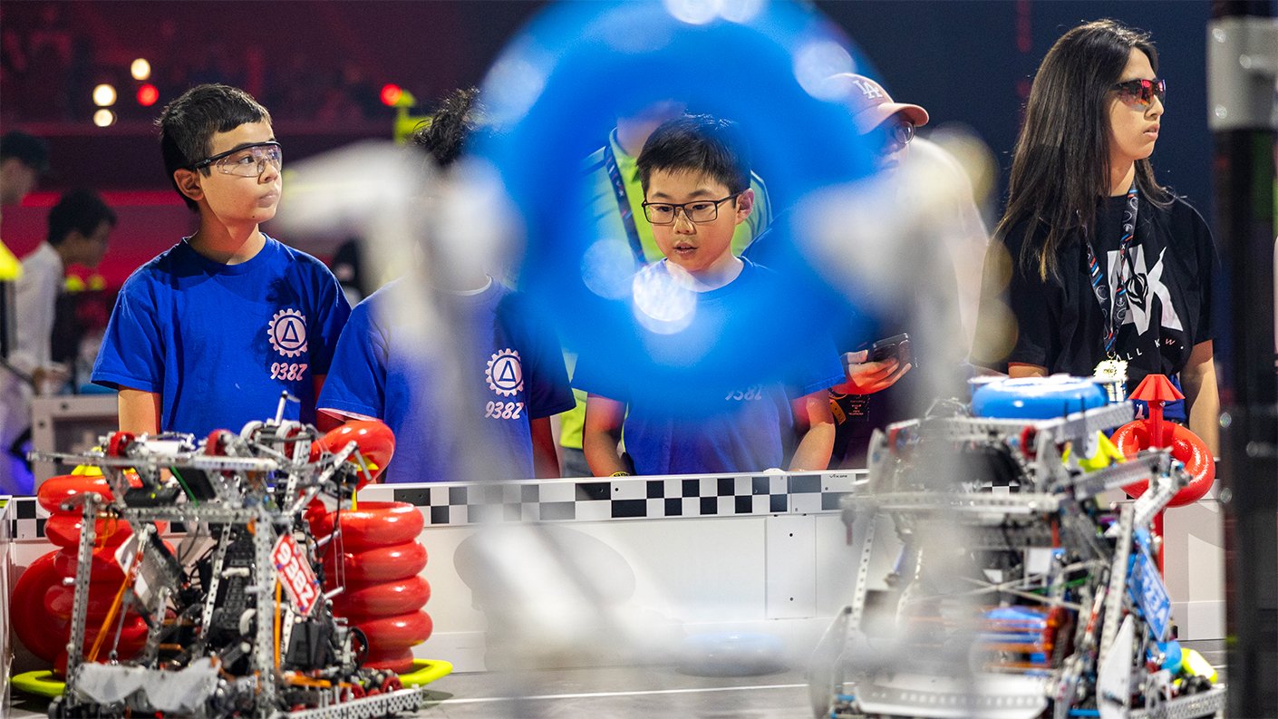 A student is pictured competing in High Stakes through the hole in the center of a game object.