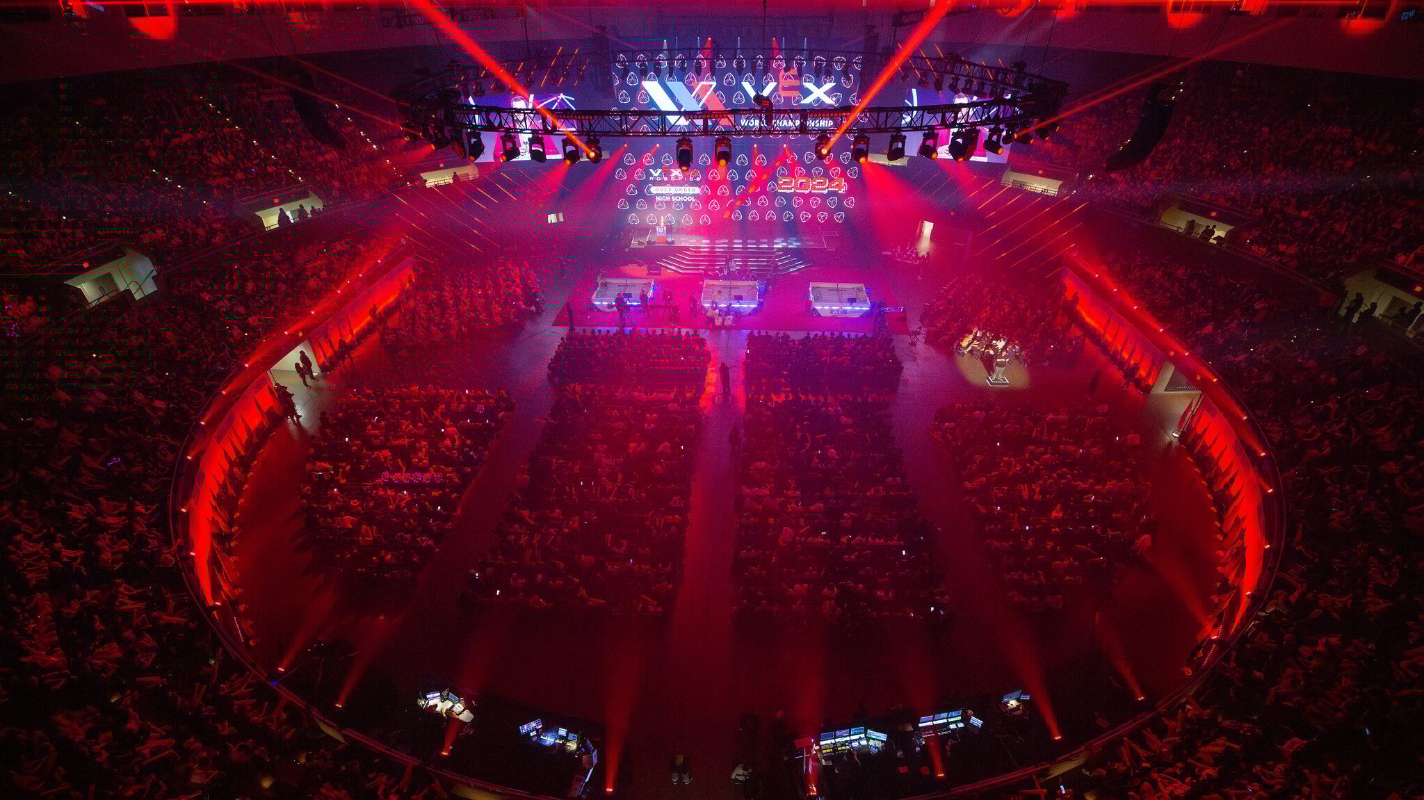 The VEX Arena is bathed in red light, pictured from above.
